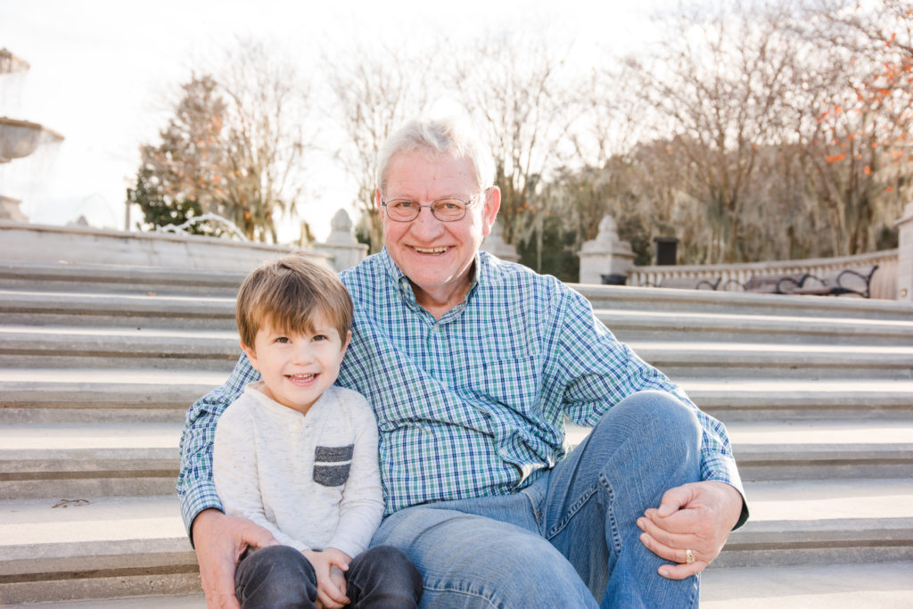 Grandfather and grandson sitting on steps in Baldwin Park Florida