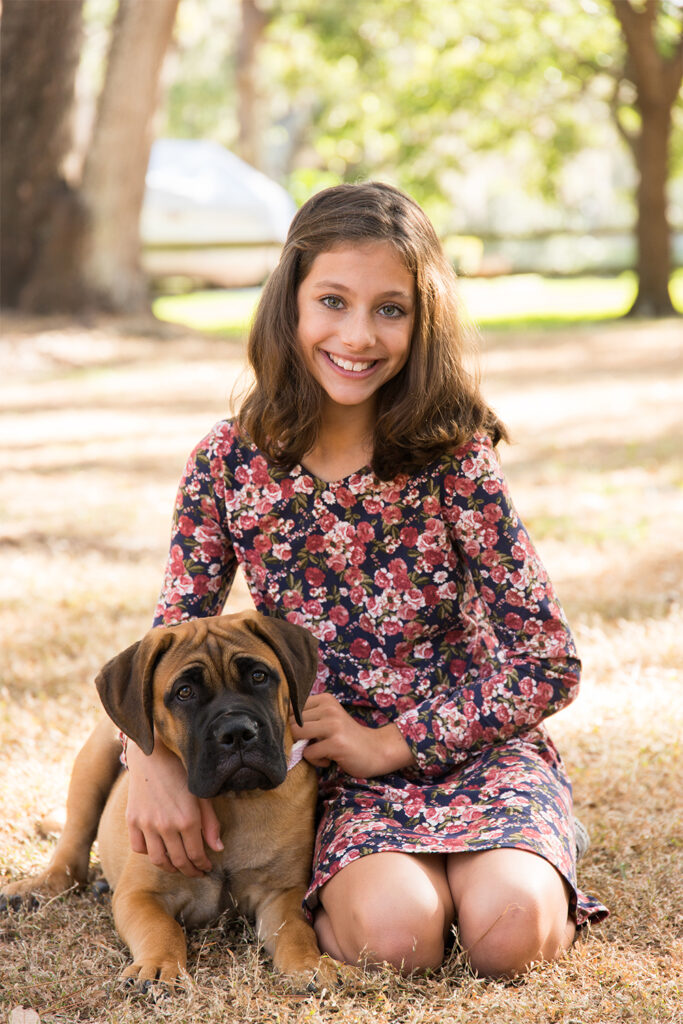 Photo of brunette 10 year old girl and her dog in Central Park in Windermere, Florida