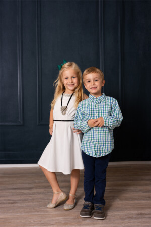 blonde 4 year old boy and 6 year old girl in studio with black wall in Winter Garden, Florida blonde 4 year old boy and 6 year old girl in studio with black wall in Winter Garden, Florida